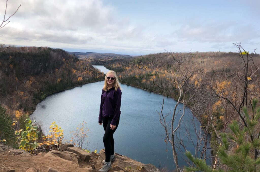 Kassidy standing at the overlook at Bean and Bear Lakes during fall.