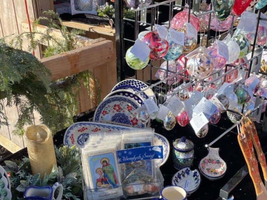 A vendor booth with Christmas ornaments for sale at a Christmas market, a thing to do in Duluth, MN in winter.